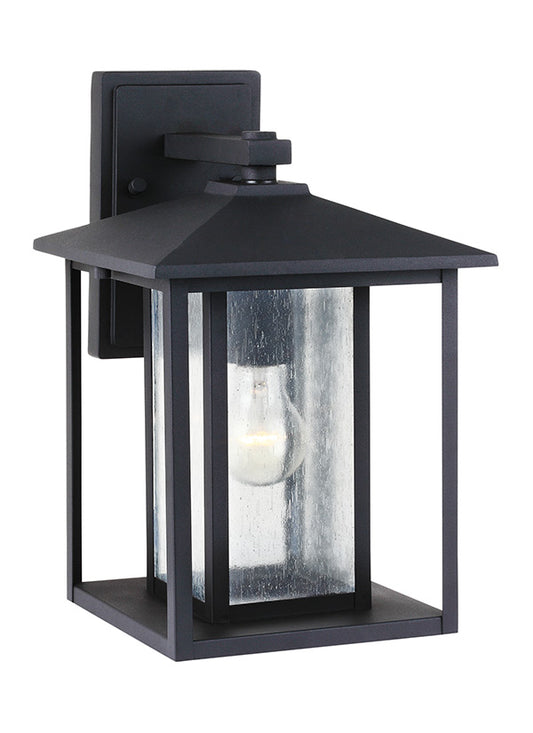 Generation Lighting Hunnington contemporary 1-light outdoor exterior medium wall lantern in black finish with clear seeded glass panels 88027-12