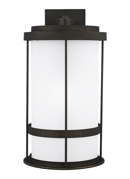 Generation Lighting Wilburn modern 1-light outdoor exterior Dark Sky compliant extra large wall lantern sconce in antique bronze finish with satin etched glass shade 8890901D-71